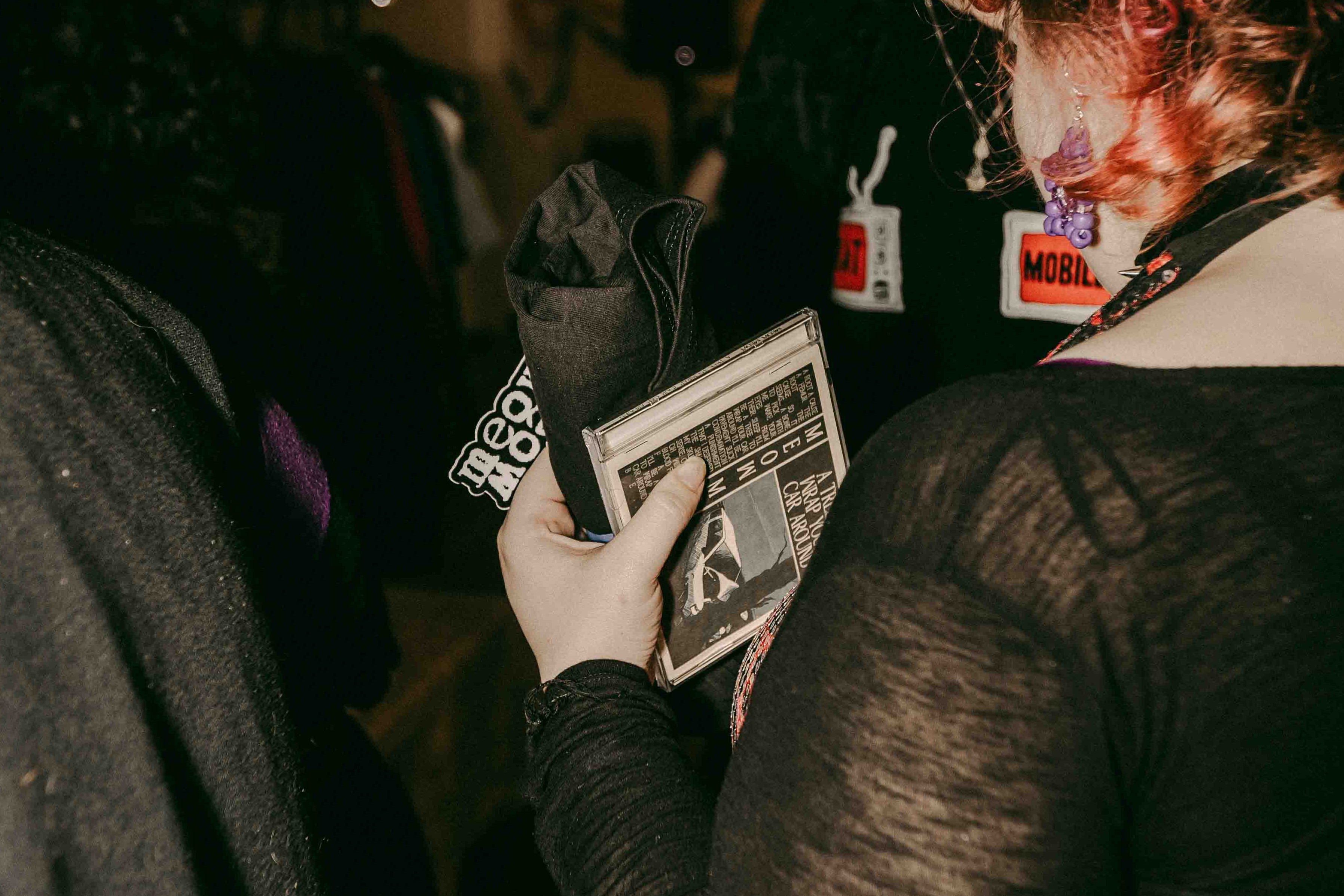 cd sticker and t shirt in hand